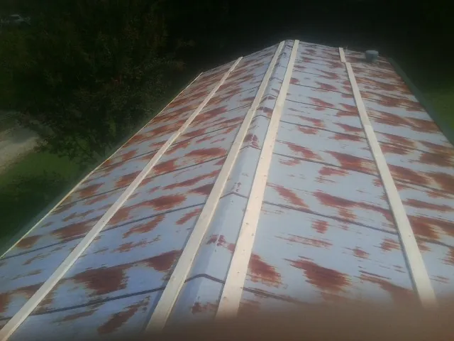 Rusted metal roof panels with new wood purlins before replacement — Storm Damage Roof Repair in Lake Waccamaw by Roofing Brothers